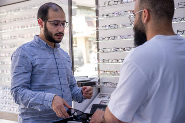 Male selecting the best eyeglasses, also selecting sunglasses which is clips eyeglasses